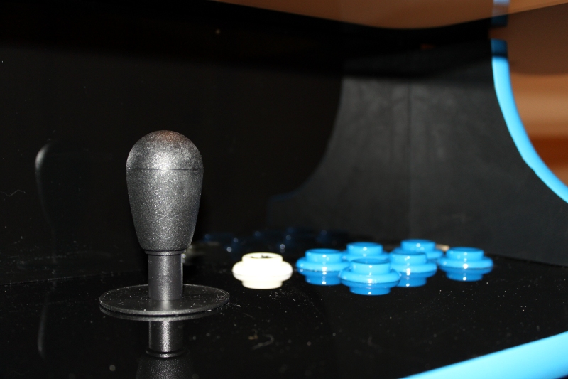 Up close shot of the joystick and shiny buttons