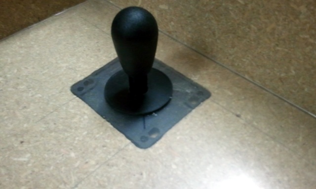 Joystick with cover disc under plexiglas