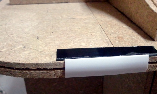 Test t-molding next to small test piece of blackened plexiglas