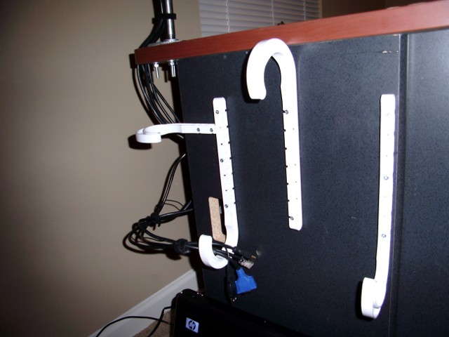 Unpainted J hooks attached to the desk